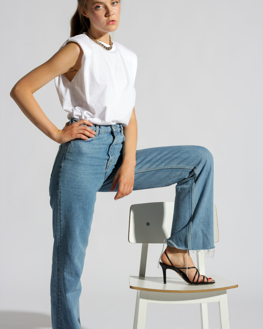 Light wash jeans worn seated