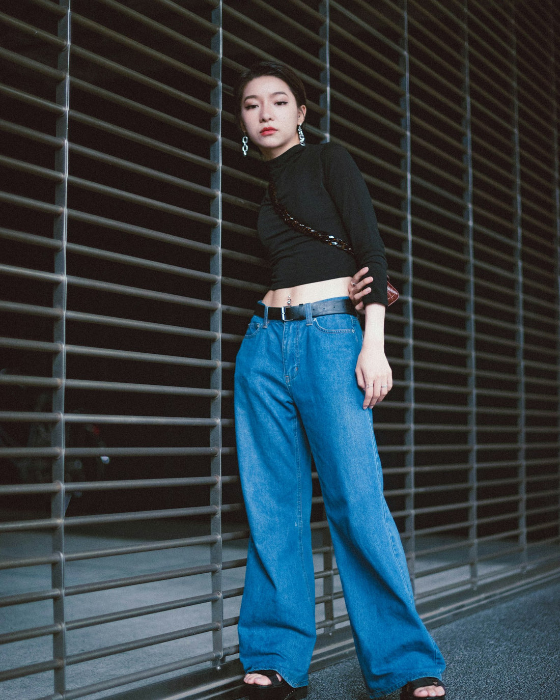 High-rise wide-leg jeans in mid wash, worn with a black top