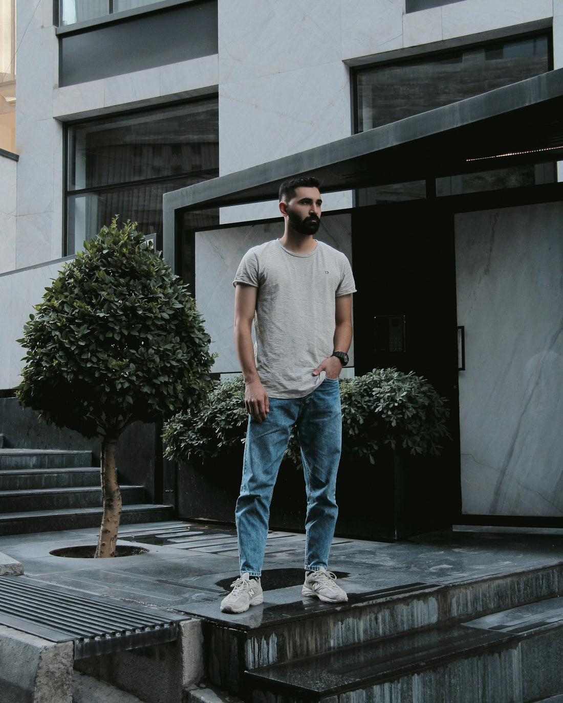 Mid wash straight jeans worn outside a building