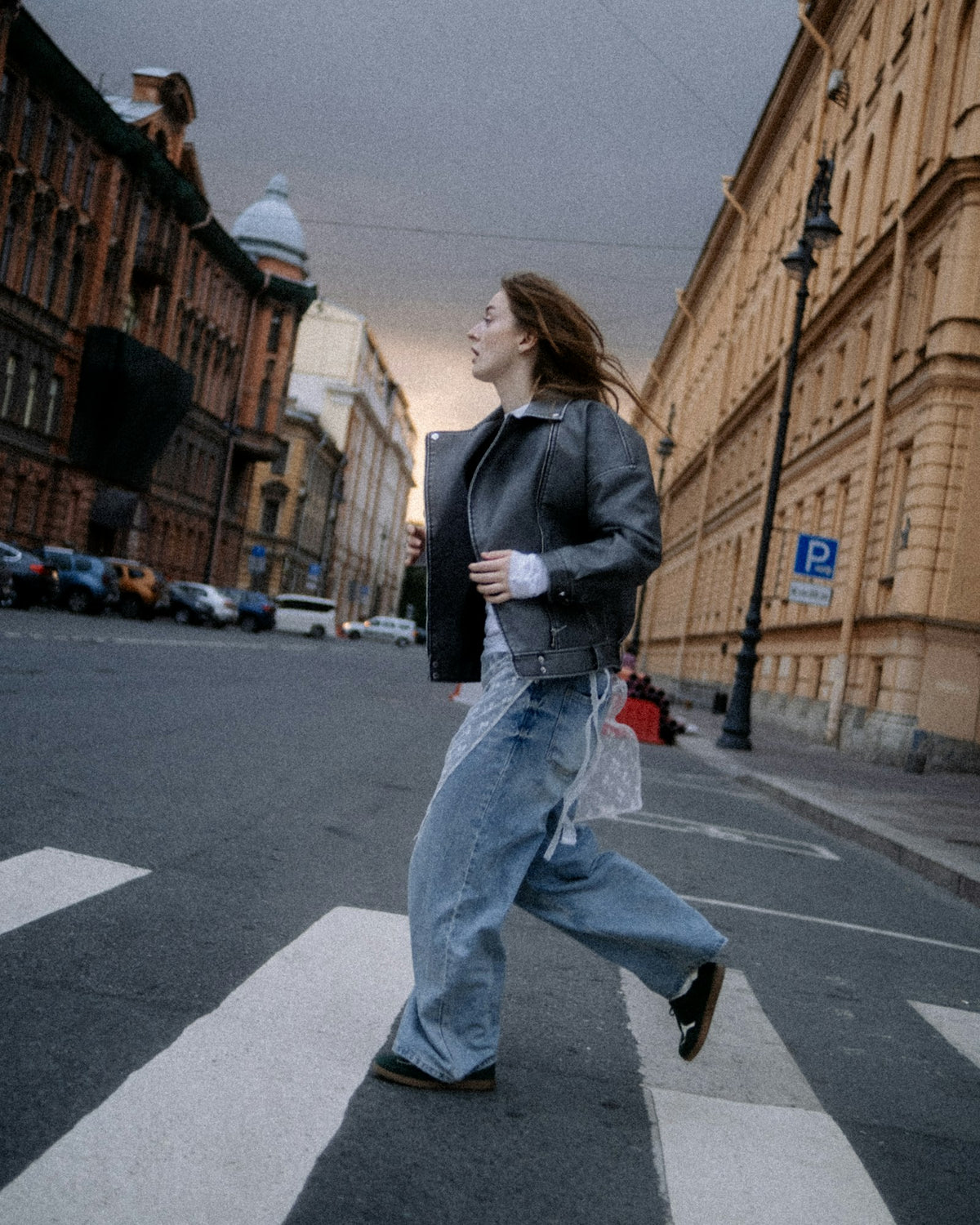 Wide-leg jeans worn crossing a city street